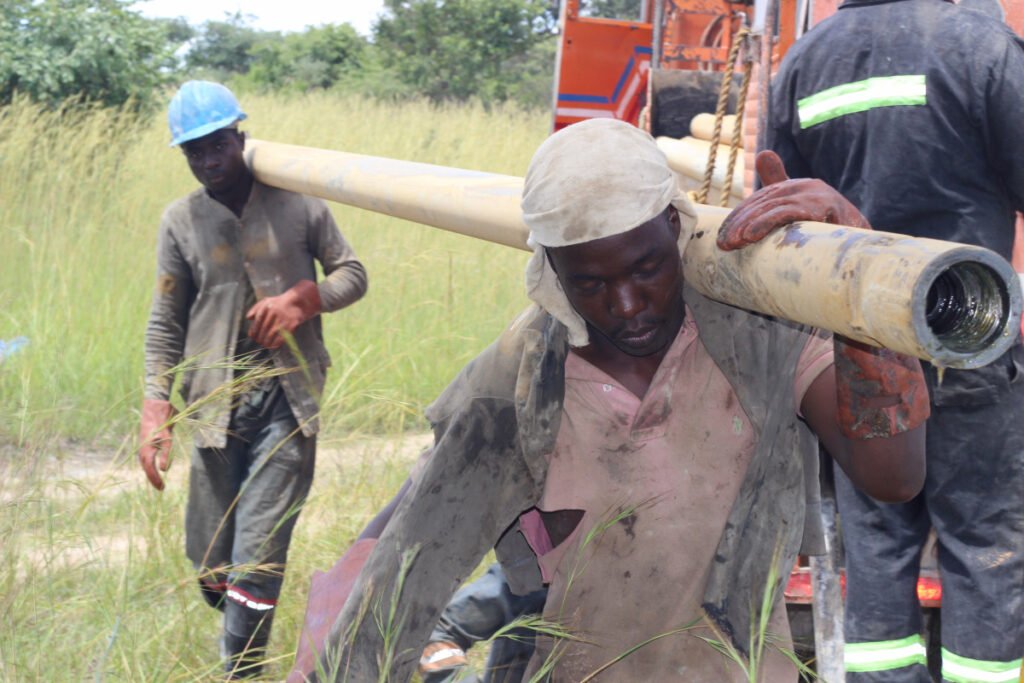 men working on borehole drilling project